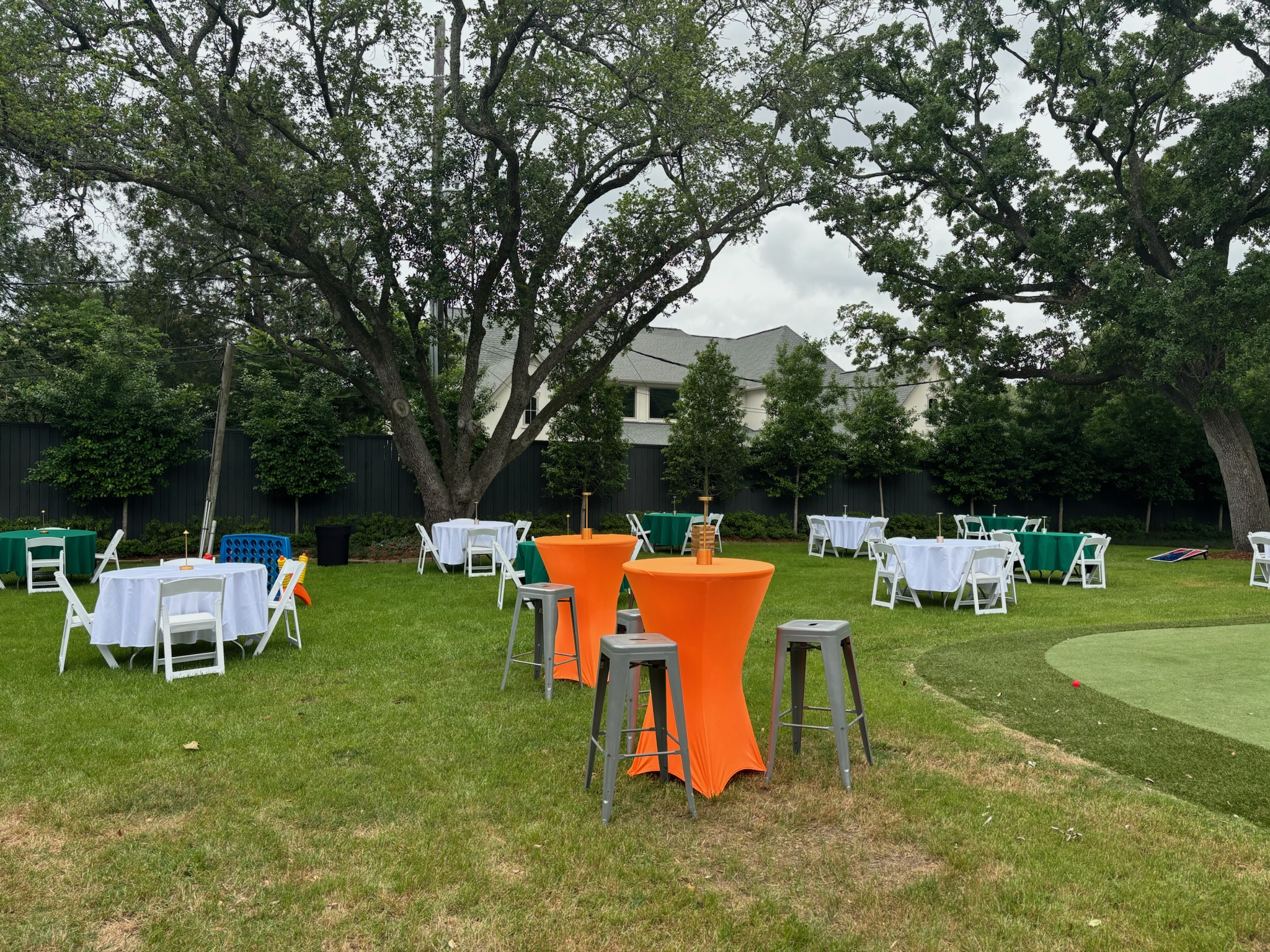 Cocktail-height tables and chairs at an outdoor Houston reception