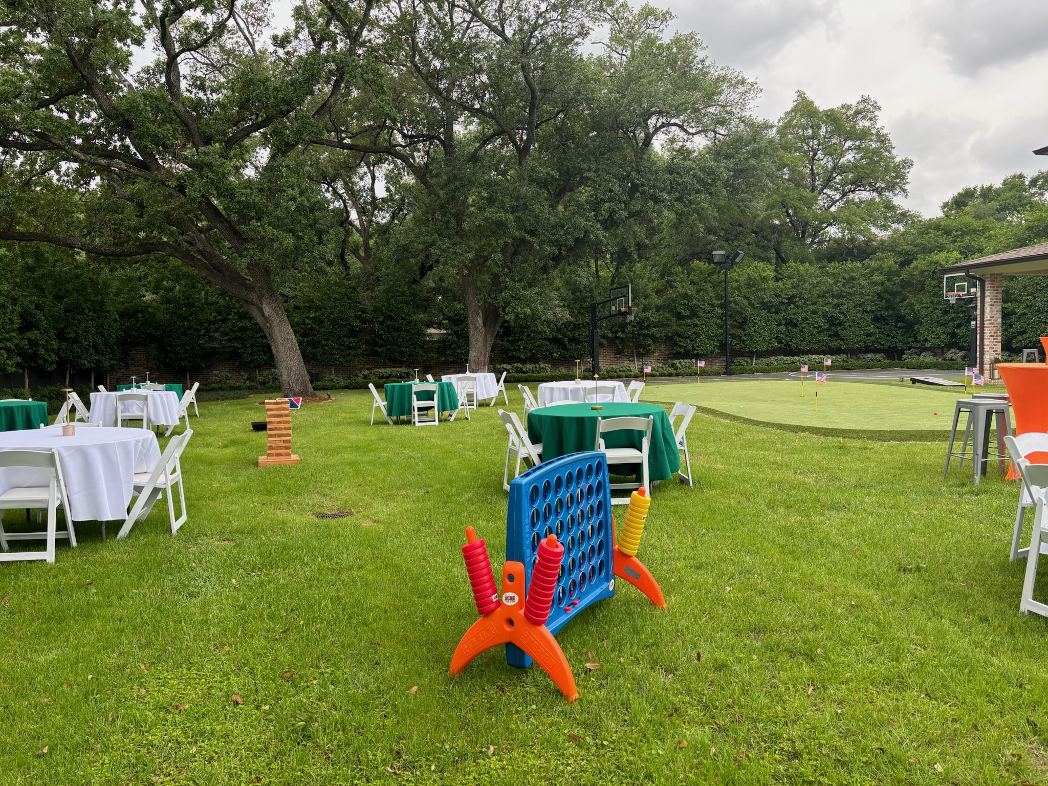 Outdoor lawn seating with event chairs at a Houston-area garden event