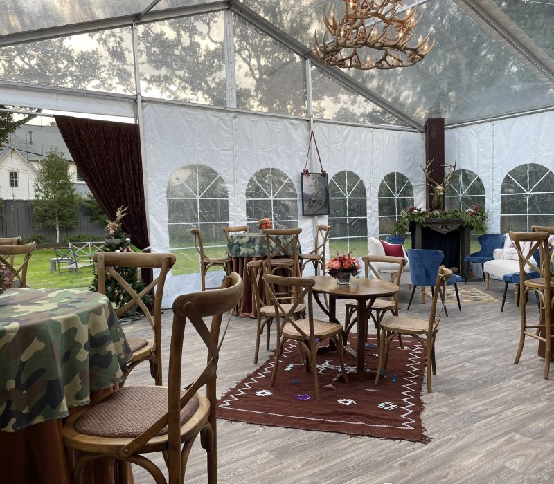 Clear top event tent set up with tables and chairs for a Houston garden event